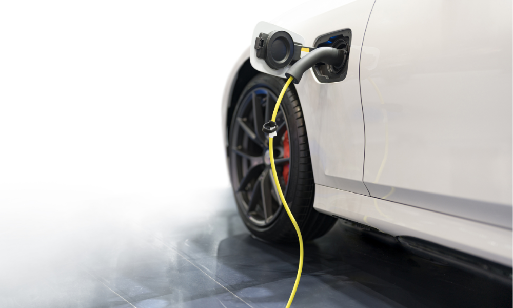 An electric car plugged into a charging cable